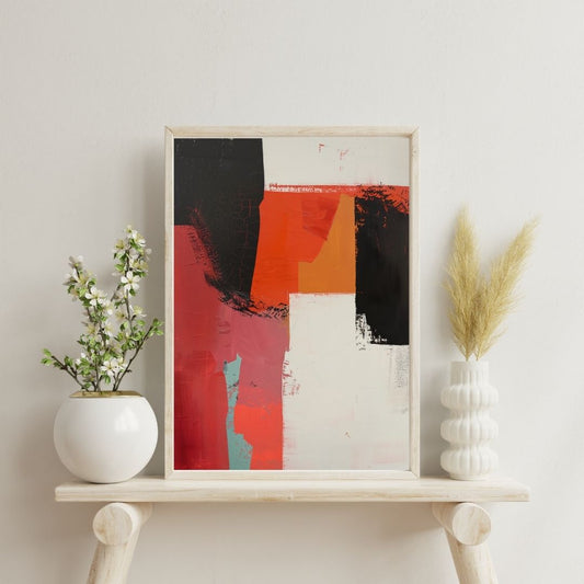 Framed abstract art piece on a shelf with decorative plants against a light wall.