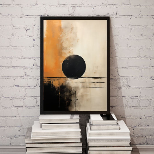 Abstract art piece with a black circle on an orange and beige background, framed and leaning against a white brick wall.