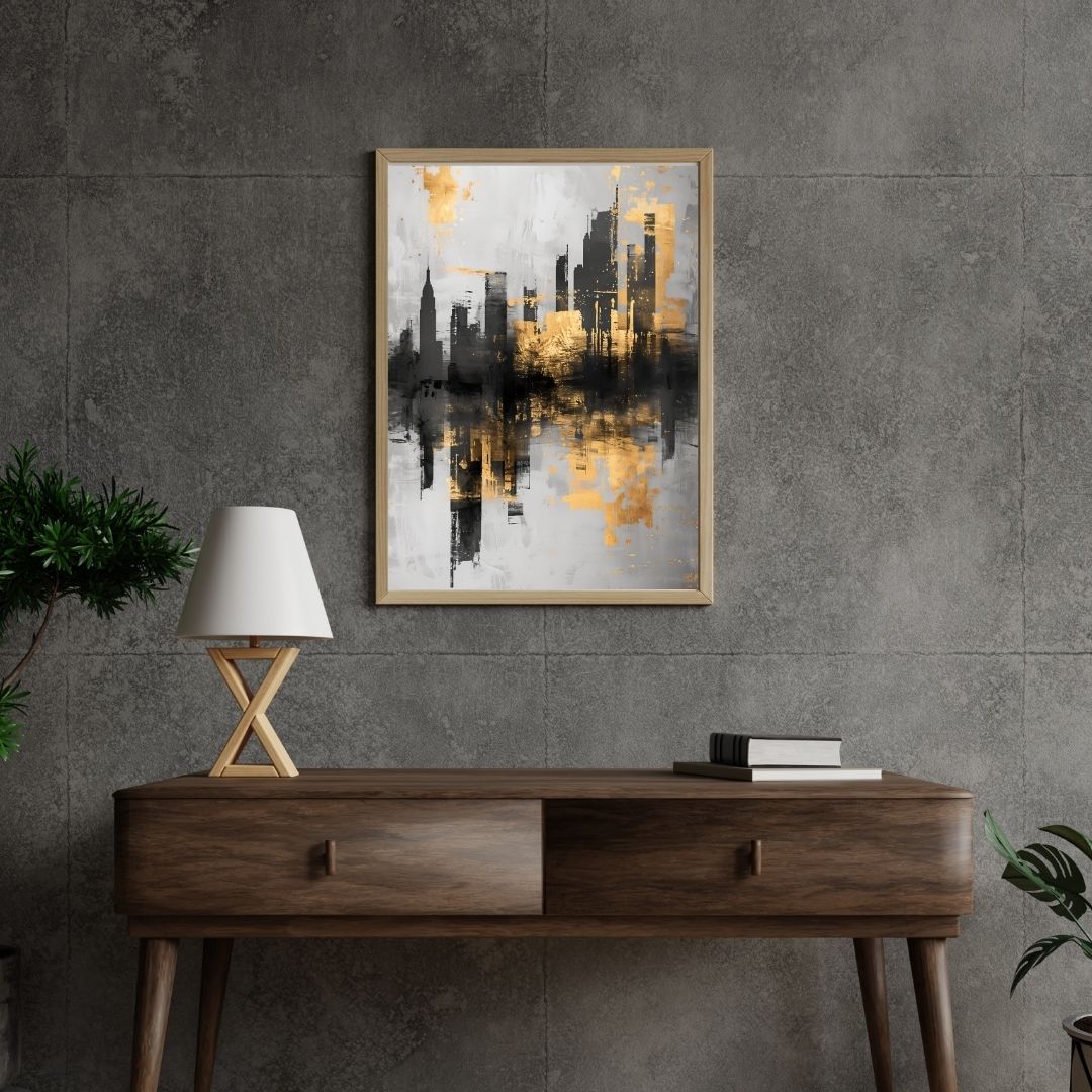Wooden console table with a lamp and books against a gray wall with framed abstract cityscape art.