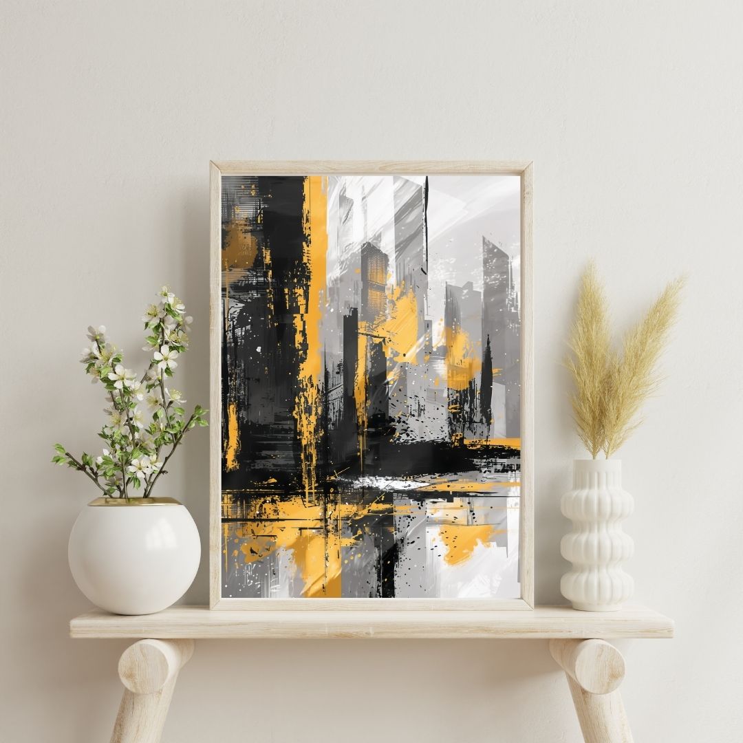Framed abstract art with yellow and black colors on a white shelf with decorative plants.
