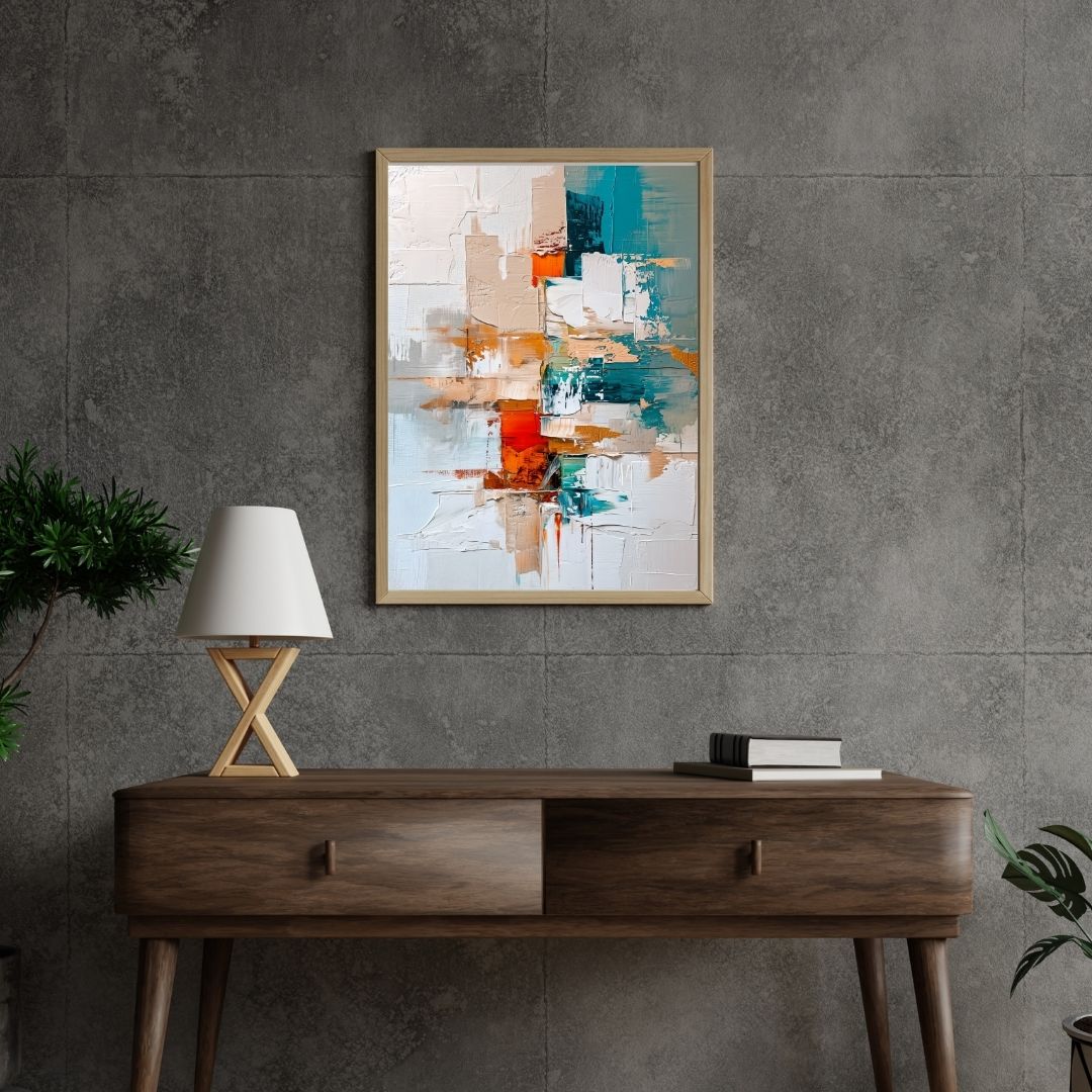 Abstract art piece on a gray wall above a wooden console table with a lamp and books.