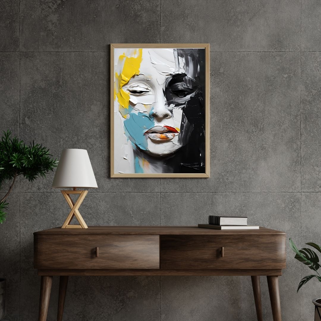 Abstract art of a face on a gray wall above a wooden console table.