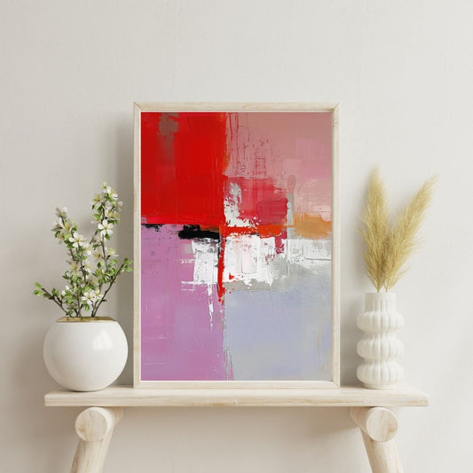 Abstract art print in a wooden frame on a shelf with decorative plants.