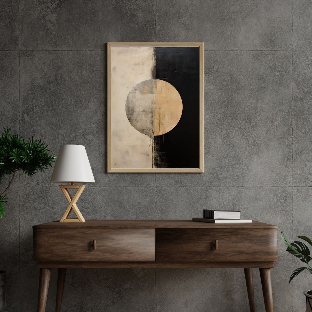 Wooden console table with a lamp and books against a gray wall with abstract art.