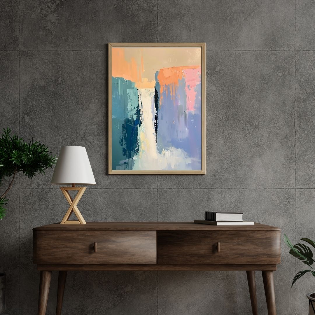 Abstract painting on a gray wall above a wooden console table with a lamp and books.