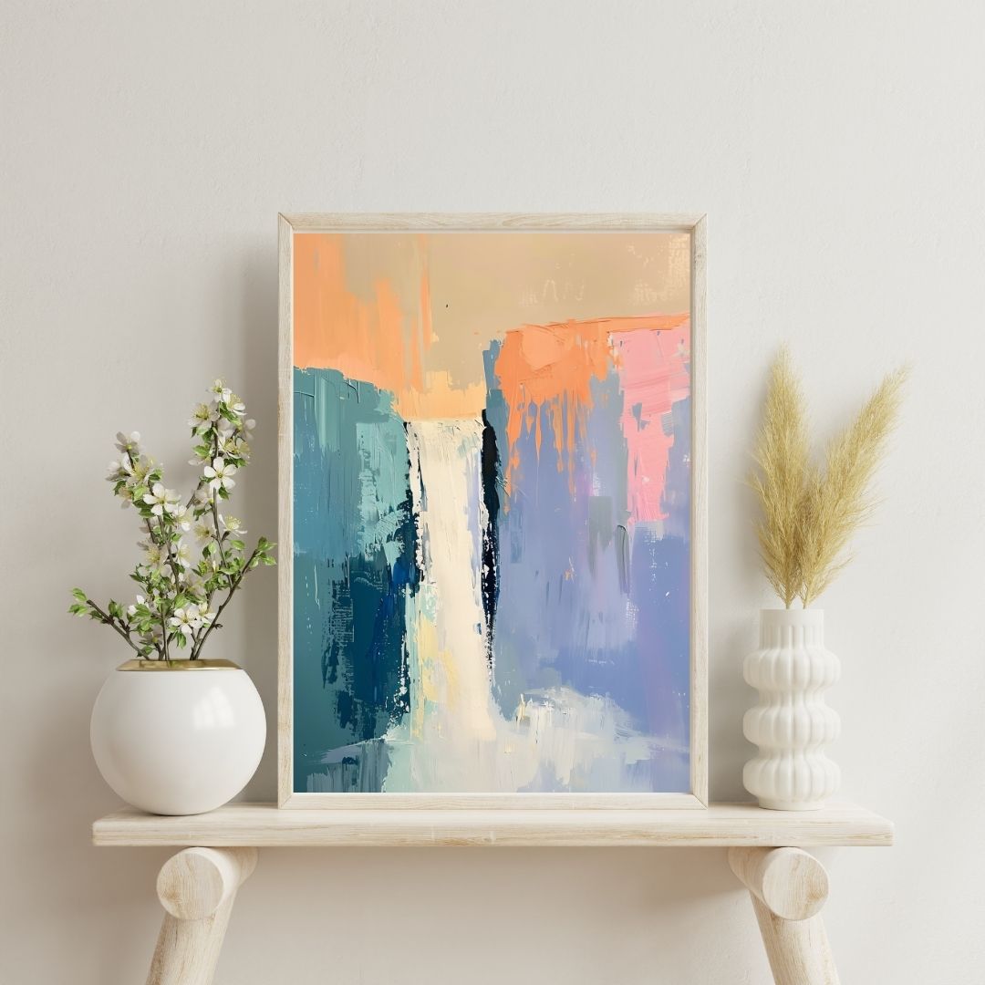 Framed abstract art piece on a shelf with decorative plants against a light wall.