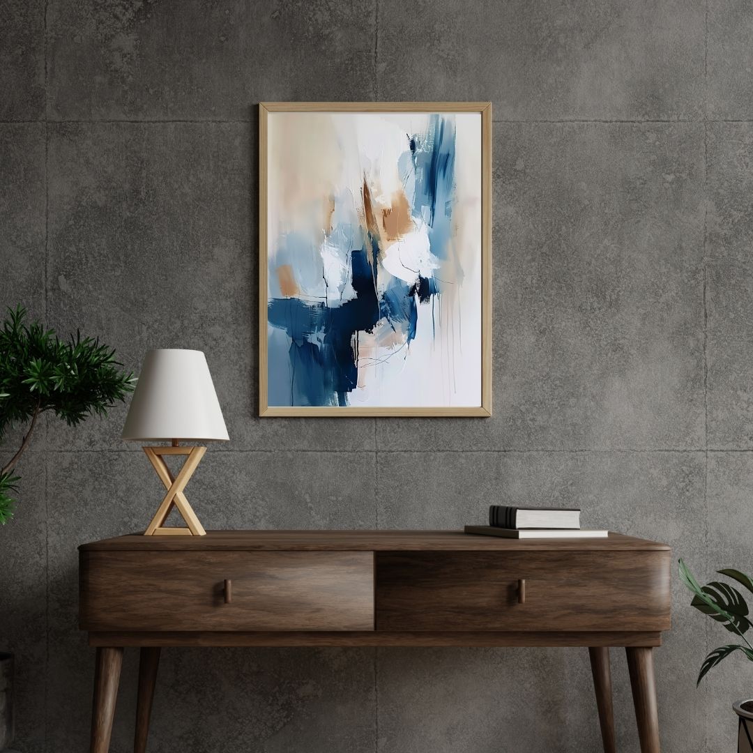 Abstract painting on a gray wall above a wooden console table with a lamp and books.