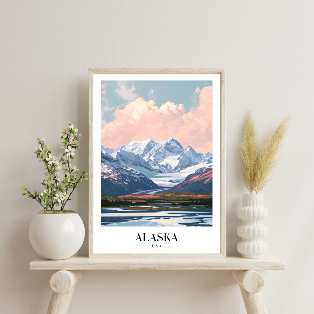 Framed artwork of a mountain landscape with 'Alaska' text on a shelf with decorative items.