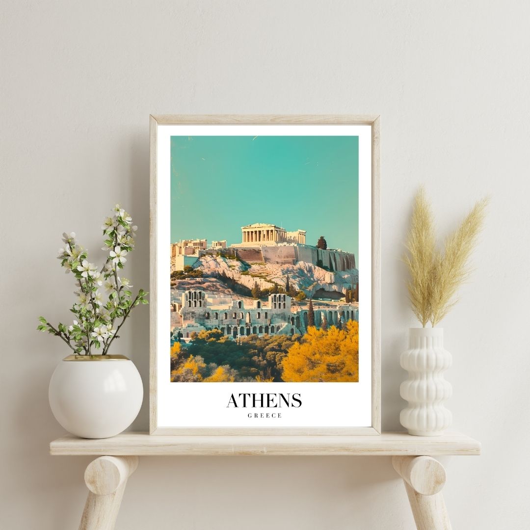 Framed artwork of Athens with decorative plants on a shelf.