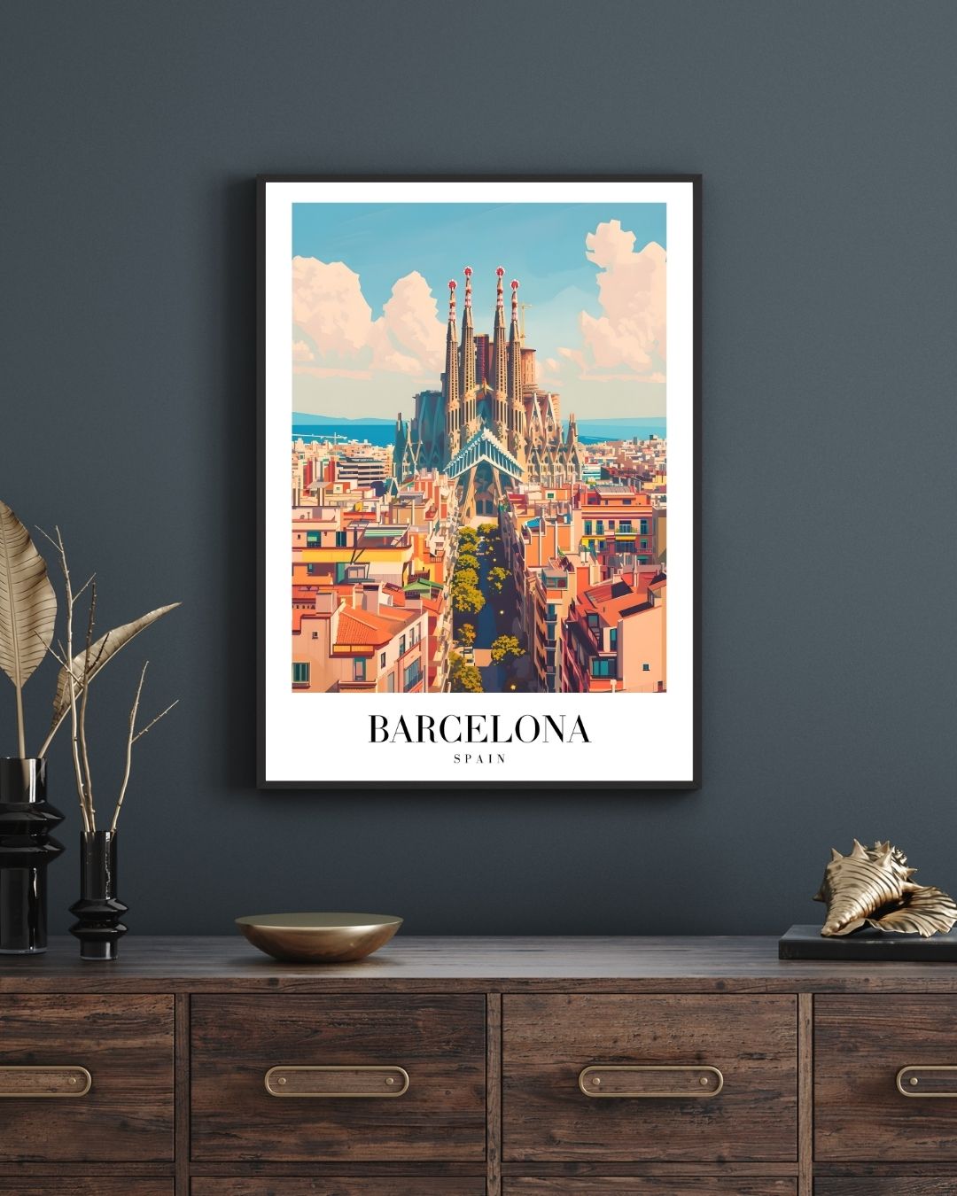 Framed artwork of Barcelona on a dark wall above a wooden cabinet.