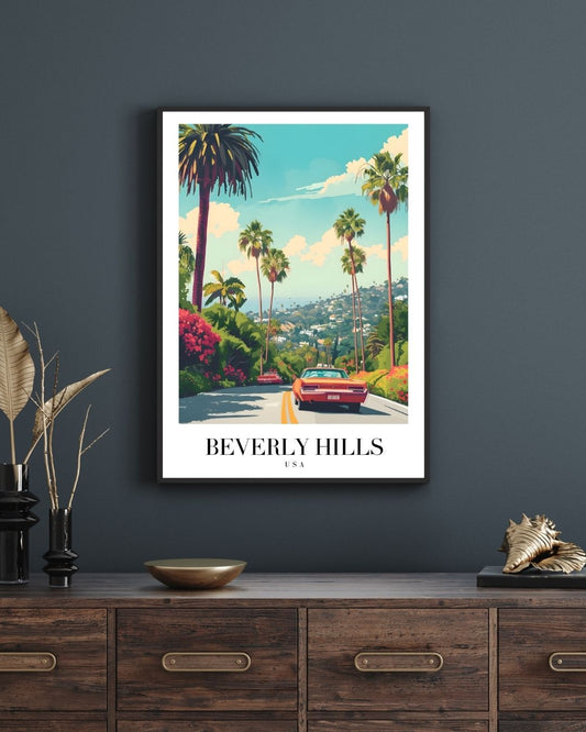 Framed artwork of Beverly Hills with palm trees and a red car on a dark gray wall above a wooden dresser.