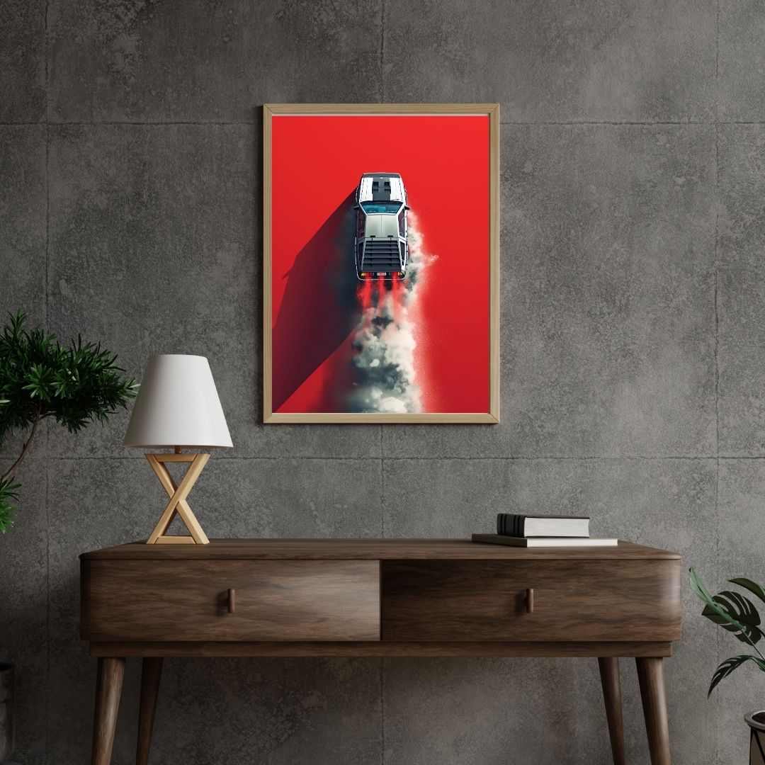 Framed poster of a red car on a gray wall above a wooden console table.