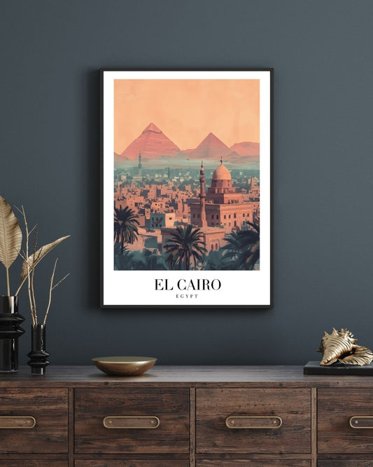 Framed artwork of El Cairo with pyramids on a dark wall above a wooden cabinet.